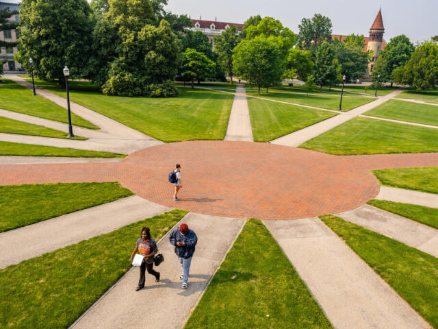 Paths leading from a central spot on the Oval with three students walking